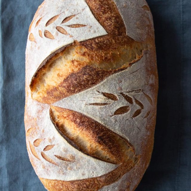 A loaf of sourdough bread. Batard or oblong shape.