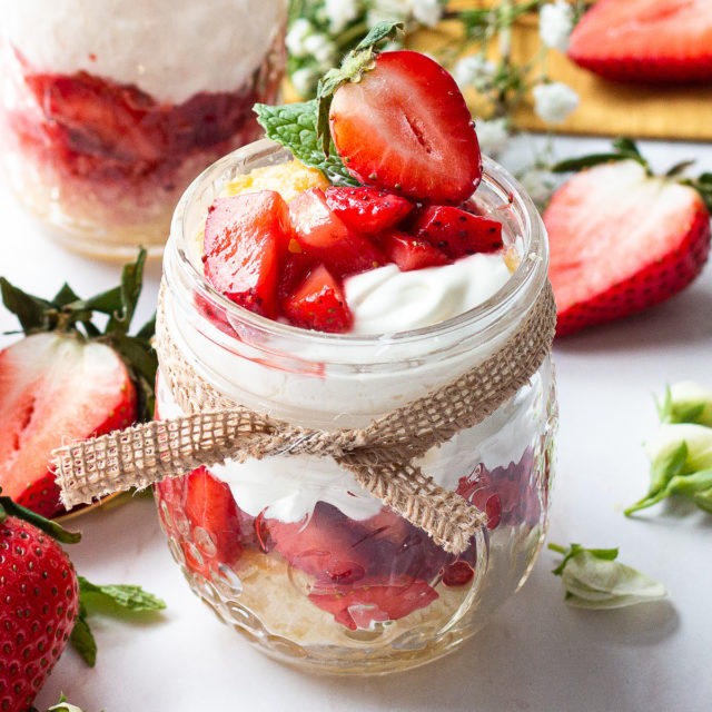 A close up a mason jar with strawberry shortcake.