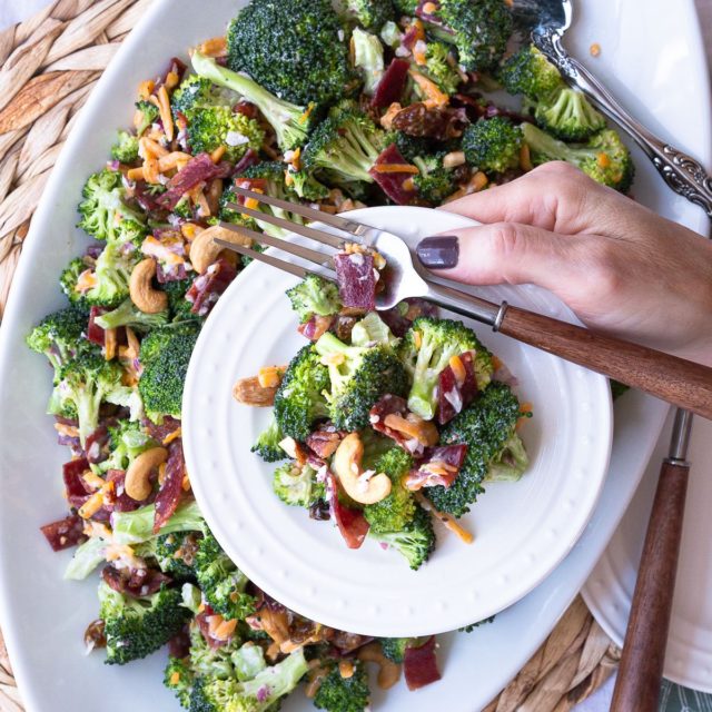 A platter of country style broccoli salad. A classic recipe with broccoli, bacon, cheddar, red onion and a creamy dressing.