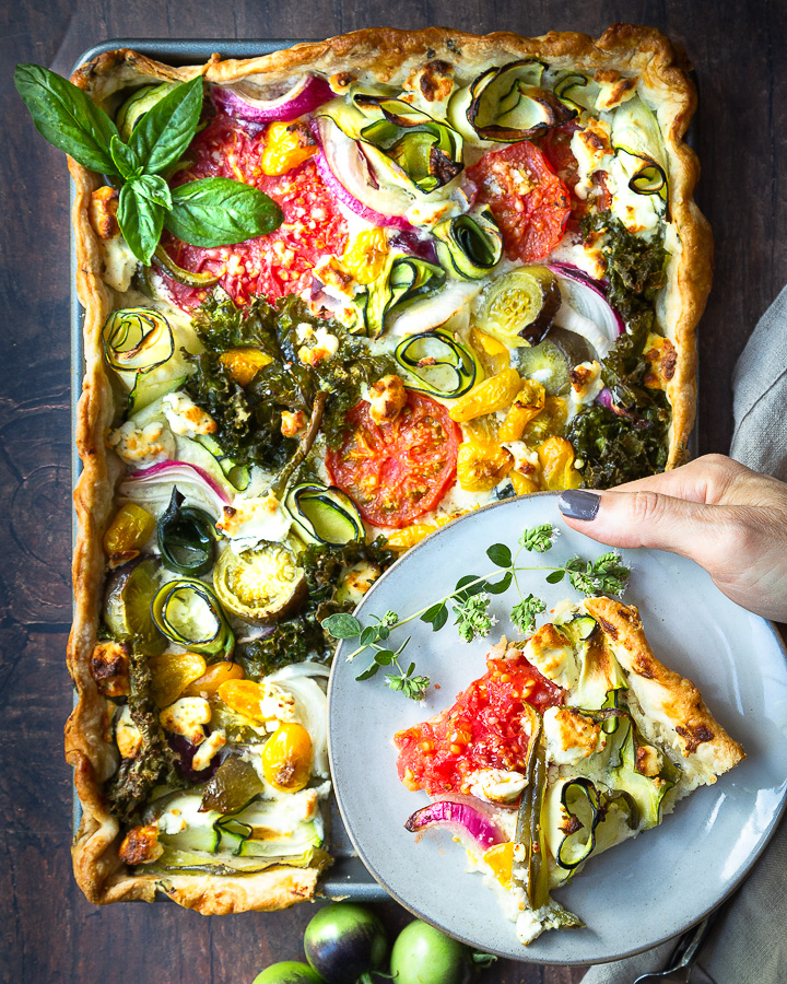 A savory garden veggie tart with tomatoes, zucchini, onion, and kale.